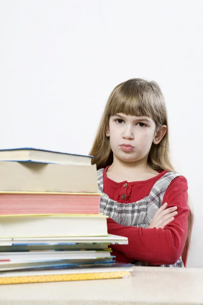 Sad girl with a pile of book — Stock Photo, Image