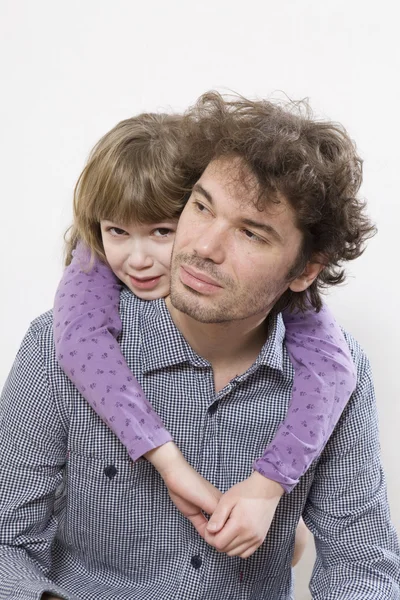 Cute young girl enjoying piggyback ride with her father — Stock Photo, Image