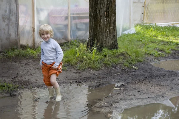 Little boy in puddle — Stock Photo, Image