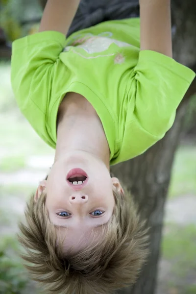 Why go to soccer practice when you can hang from a tree in the backyard? — Stock Photo, Image