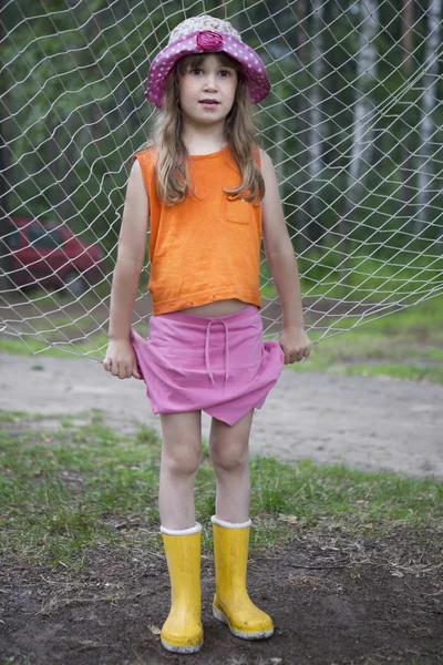 Pouco bonito menina no panamá vestindo mocassins de água de borracha . — Fotografia de Stock