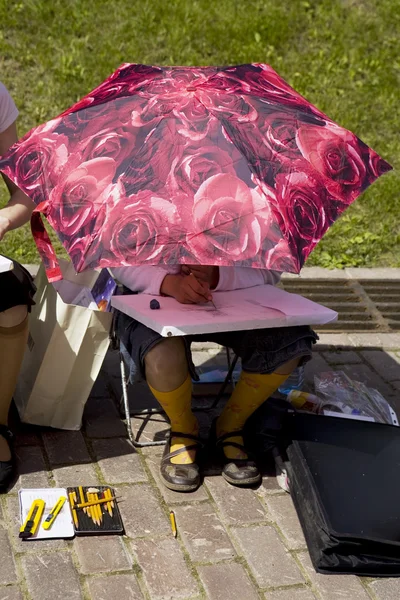 Menina sob guarda-sol desenhar algum quadro — Fotografia de Stock