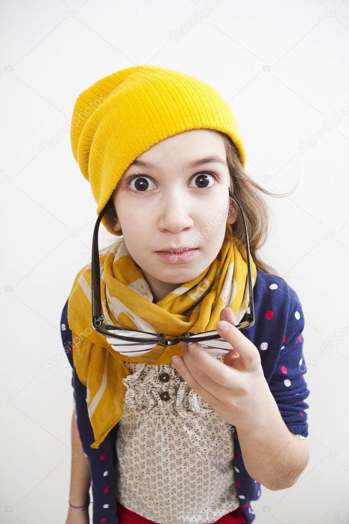 Silly little girl ten years old in yellow knitting  hat