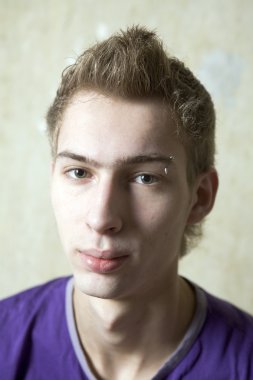 Mavi gömlekli piercing ile genç çocuk