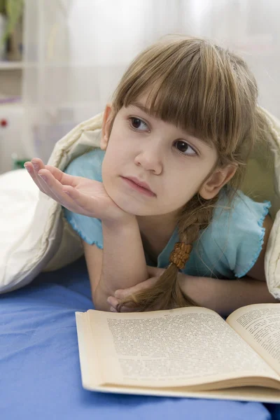 Little girl with bear on sofa — Stock Photo, Image