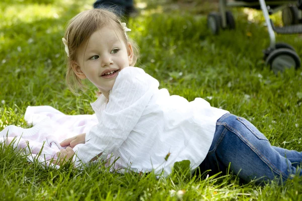 Little girl resting on meadow — Stock Photo, Image