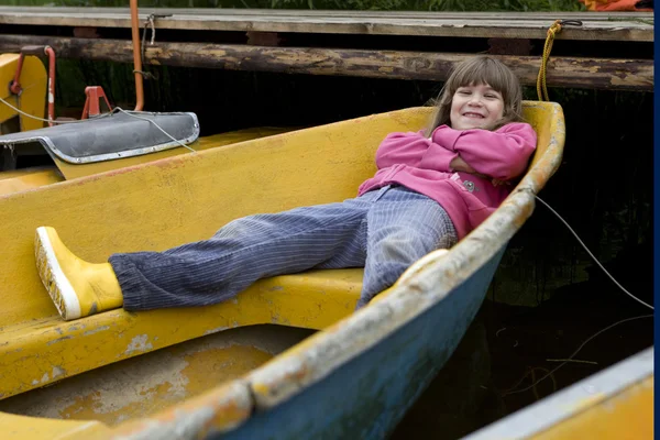 Children playing in yellow boat — Stock Photo, Image