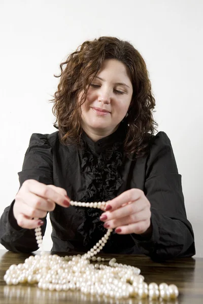 Young attractive curl woman count one's beads — Stock Photo, Image