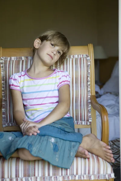 Girl sitting on chair — Stock Photo, Image