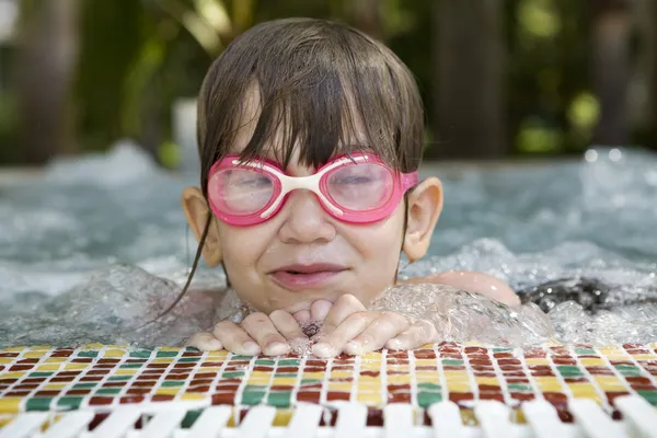 Young girl in swimming pool with jacuzzi