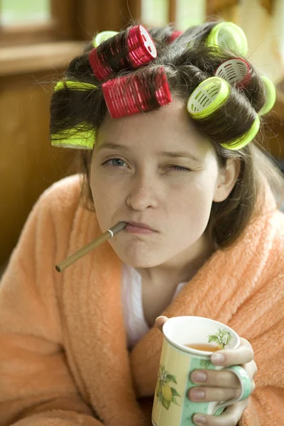 Beautiful girl in hair curlers. — Stock Photo, Image