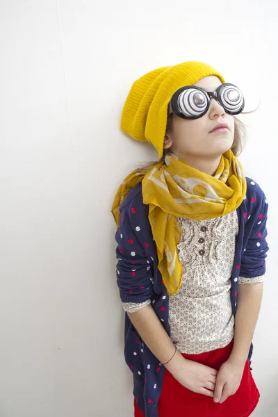 Silly little girl ten years old in yellow knitting  hat — Stock Photo, Image