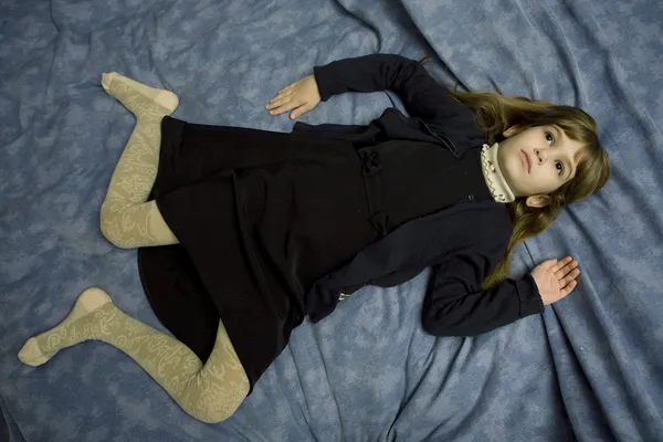 Porträt eines jungen Mädchens, das am Bett liegt — Stockfoto