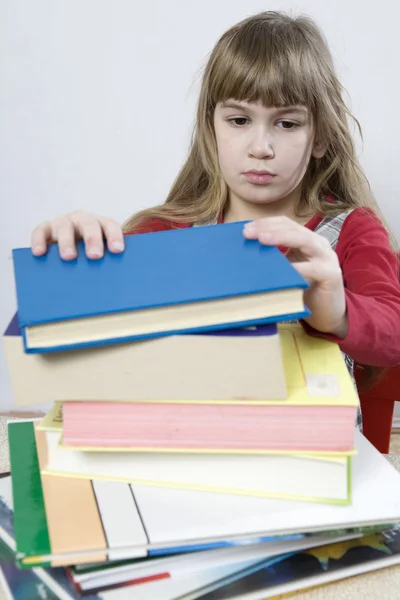 Chica triste con un montón de libro — Foto de Stock
