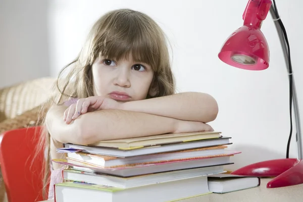 Unhappy little girl studying — Stock Photo, Image