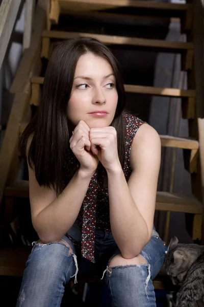 Young attractive  girl sitting on stairs — Stock Photo, Image