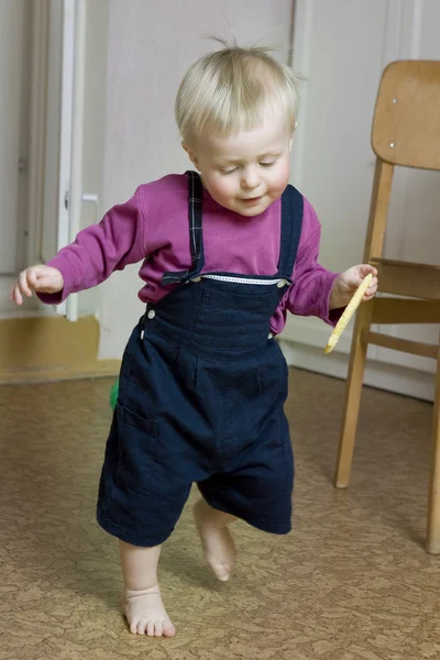 Little cute blond boy one years old walking around room — Stock Photo, Image