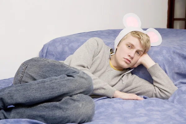 Portrait of young man wearing  rabbit ears — Stock Photo, Image