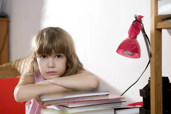 Unhappy little girl studying — Stock Photo, Image
