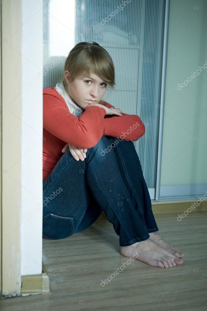 Young sad girl sitting on corner in room. Teen problem — Stock Photo ...