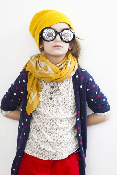 Silly little girl ten years old in yellow knitting  hat — Stock Photo, Image