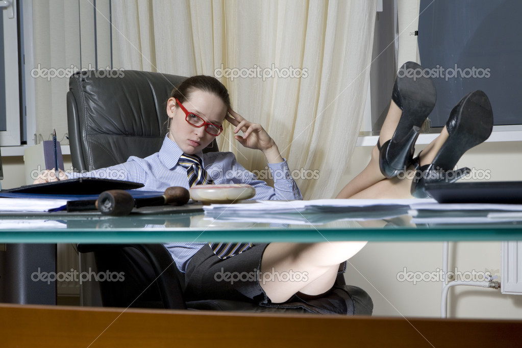 Boss Sitting On Chair Put Her Legs On Table Stock Photo