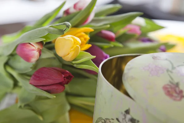 Tulips lying near vintage box — Stock Photo, Image