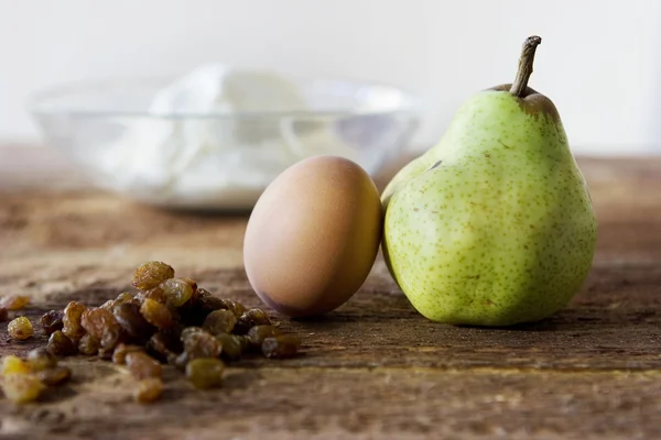 Pear, eggs, rasins and cheese in plate on the table — Stock Photo, Image