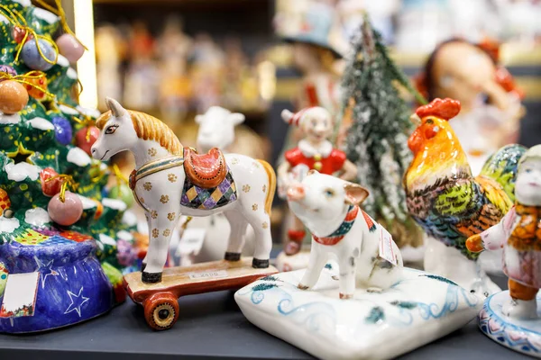 Moscow, Russia - 20 December 2021 festivities on the Manezhnaya Square in Moscow. festival Christmas trip. Glass Christmas toys for sale at the fair. Horses, pigs, animals