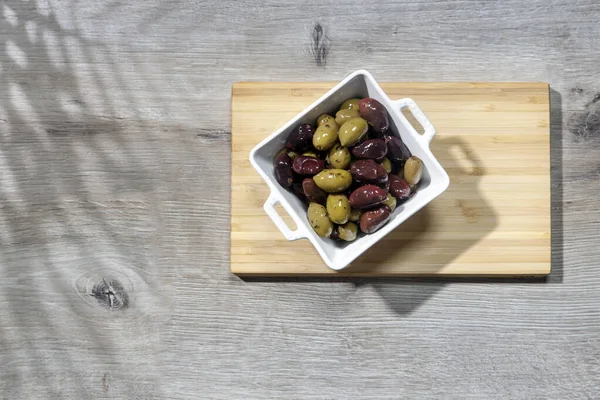 Deep Square Porcelain Bowl Green Dark Olives Wooden Board Shadow — Stock Photo, Image