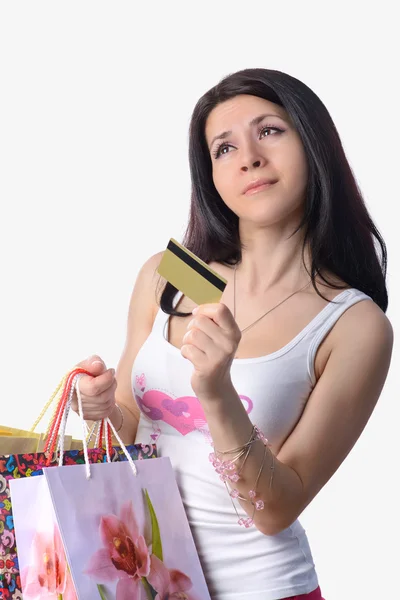 Het mooie meisje met een credit card en tassen — Stockfoto