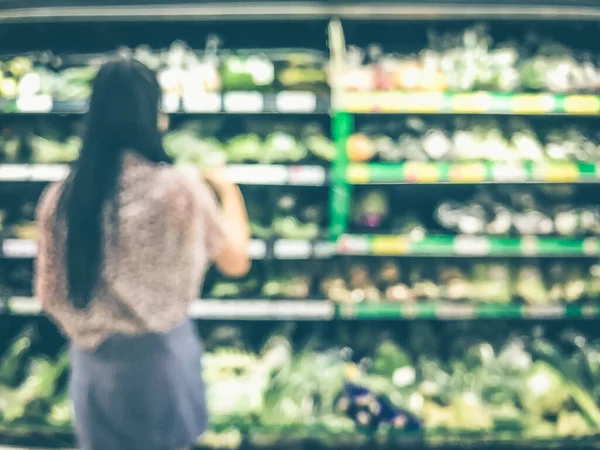 Blur woman shopping at food department background