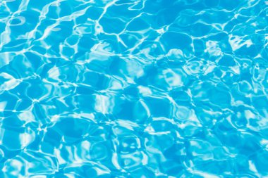 Güneşi yansıtan mavi havuz suyu