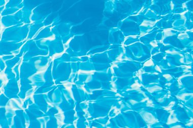 Güneşi yansıtan mavi havuz suyu