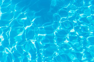 Güneşi yansıtan mavi havuz suyu