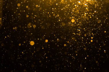 Siyah arkaplan ile soyut altın bokeh