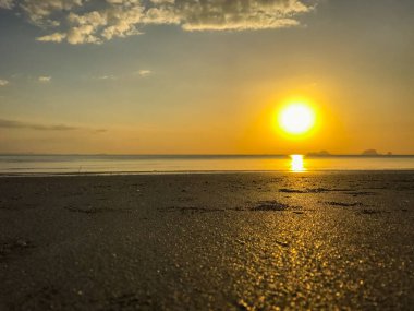 Sahilde gökyüzü ve gün batımından önce tekne.