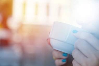 Arka planda bulanık kahve içen kadın.