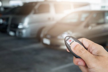 Otoparkın arka planında el ele tutuşan uzaktan kumanda