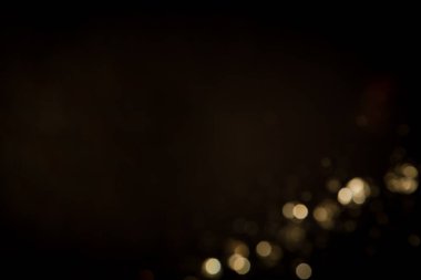 Siyah arkaplanda altın soyut bokeh