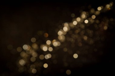 Siyah arkaplanda altın soyut bokeh