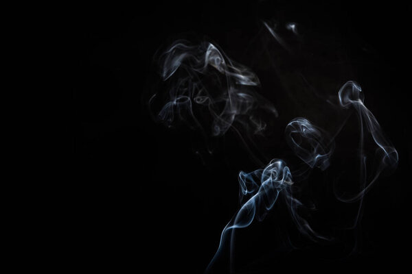 Abstract smoke swirls on black background