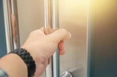 Elle açılan metal, modern ofis kapısı.