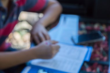 Masa arkasında kamera ve akıllı telefon ile uygulamayı dolduran adamın bulanık görüntüsü