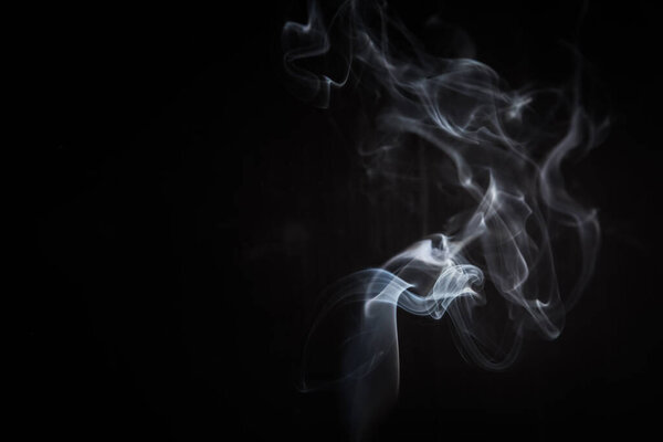 Abstract smoke swirls on black background