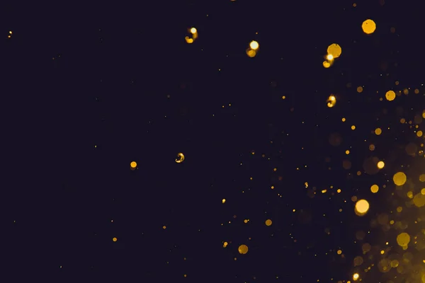 Siyah arka plan üzerinde soyut altın bokeh