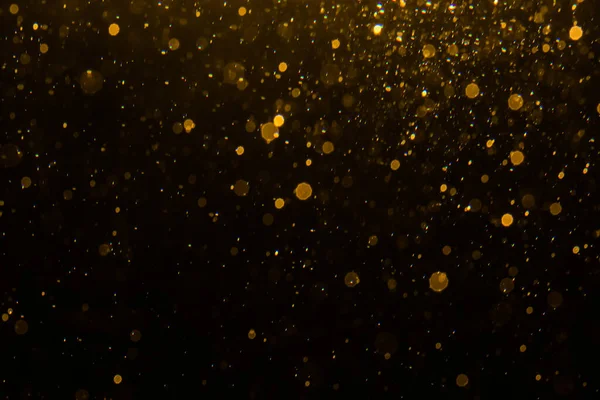 Siyah arkaplan ile soyut altın bokeh