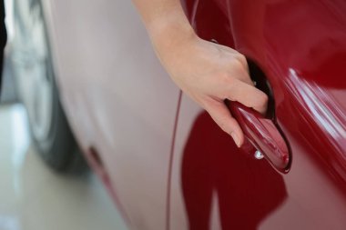 Kadın elini uzat ve yeni arabanın arka planını aç.