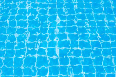 Mavi yüzme havuzunun arka planındaki sudan yansımalar.