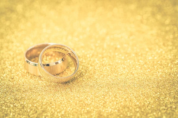 Goldene Trauringe Von Braut Und Bräutigam Auf Gold Glitzerndem Hintergrund — Stockfoto